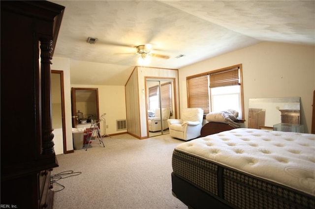 bedroom with lofted ceiling, light colored carpet, visible vents, and ceiling fan