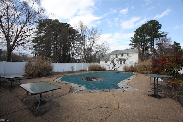 view of swimming pool featuring a patio, a fenced backyard, and a fenced in pool