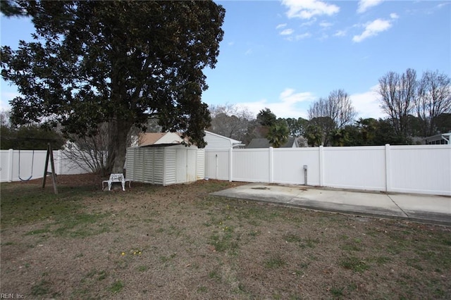 view of yard featuring an outbuilding, a shed, and a fenced backyard