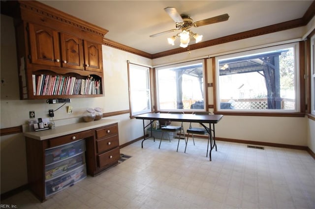 interior space with light floors, baseboards, visible vents, ornamental molding, and light countertops