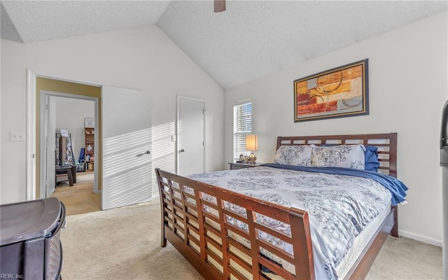 bedroom with carpet floors, a textured ceiling, ceiling fan, and vaulted ceiling