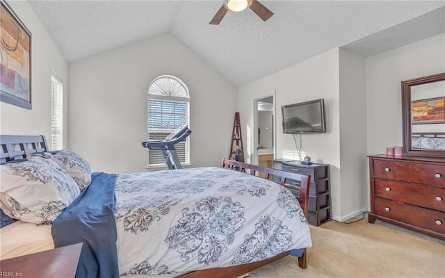 carpeted bedroom featuring ceiling fan, vaulted ceiling, and a textured ceiling