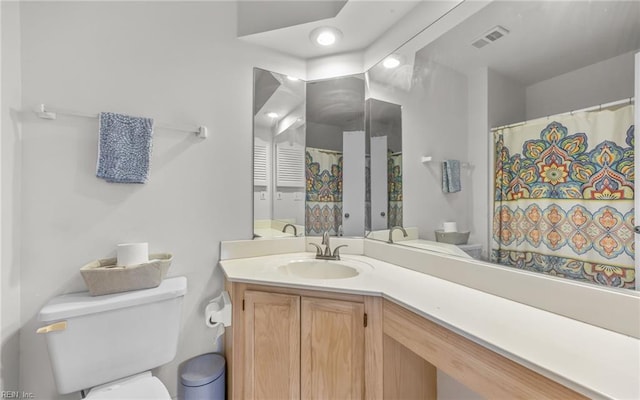 full bath with visible vents, toilet, and vanity