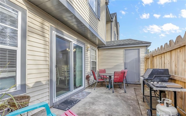 view of patio / terrace with outdoor dining space, area for grilling, and fence