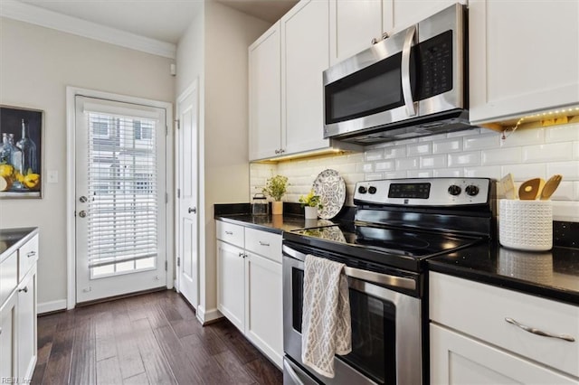 kitchen featuring tasteful backsplash, appliances with stainless steel finishes, dark countertops, and a wealth of natural light