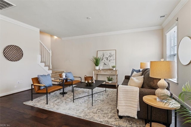 living area with visible vents, wood finished floors, crown molding, baseboards, and stairs