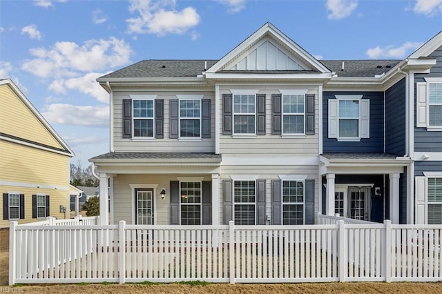 view of front of house with a porch, board and batten siding, and fence