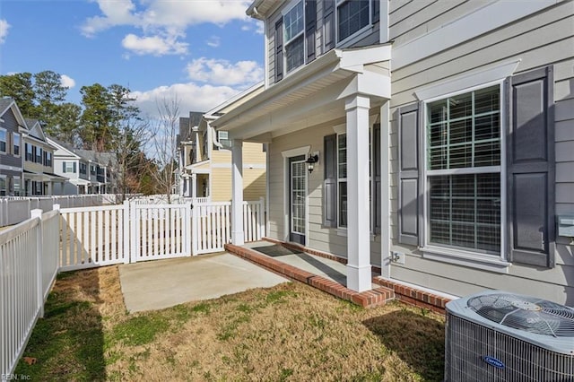 exterior space with central air condition unit, a residential view, a patio, and fence