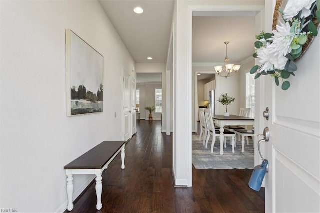 entrance foyer featuring a wealth of natural light, baseboards, and dark wood finished floors