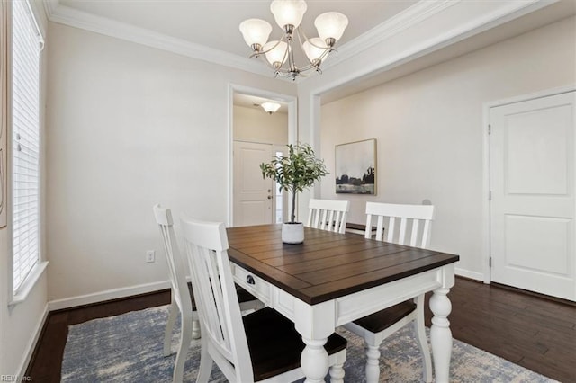 dining area featuring crown molding, baseboards, dark wood-style flooring, and a chandelier