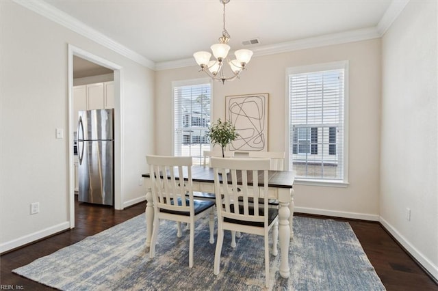 dining room featuring visible vents, ornamental molding, and dark wood-style flooring