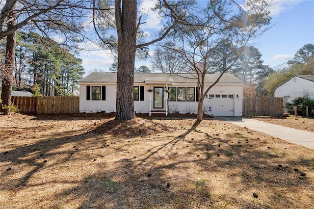 single story home with a garage, entry steps, fence, concrete driveway, and crawl space