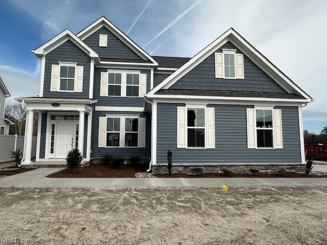 craftsman inspired home featuring fence