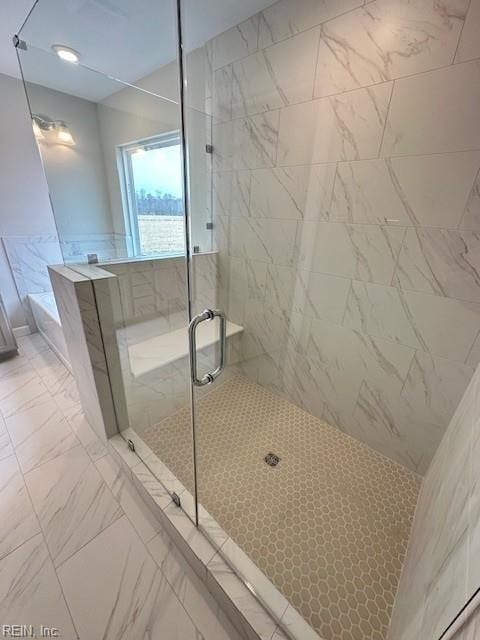 full bathroom with a shower stall, marble finish floor, and a garden tub