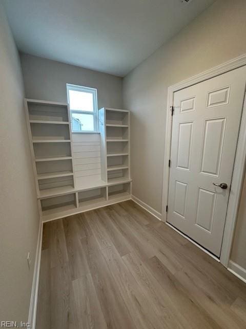 interior space with baseboards and wood finished floors