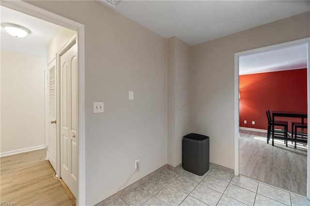 empty room with baseboards and light wood finished floors