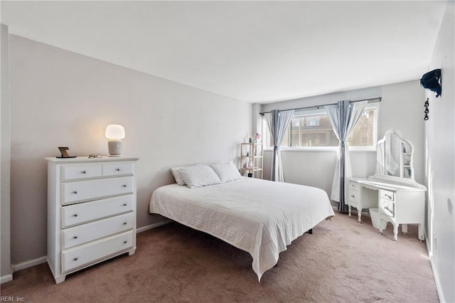 carpeted bedroom featuring baseboards