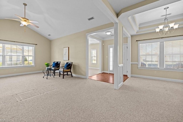 living area featuring plenty of natural light, visible vents, crown molding, and carpet