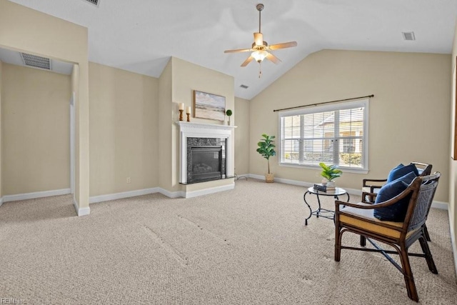 sitting room with baseboards, carpet, lofted ceiling, a premium fireplace, and a ceiling fan