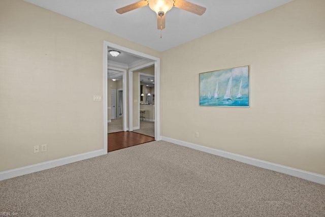 spare room featuring a ceiling fan, baseboards, and carpet floors