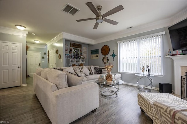 living area featuring baseboards, wood finished floors, visible vents, and ceiling fan