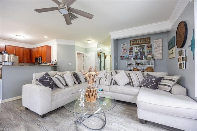 living area with light wood-style flooring, a ceiling fan, and ornamental molding