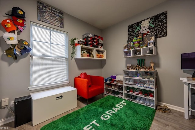 rec room with wood finished floors and baseboards