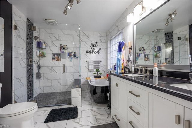 full bath with a shower stall, tile walls, marble finish floor, and a sink