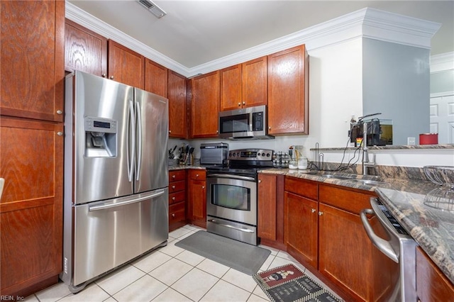 kitchen with light tile patterned floors, visible vents, appliances with stainless steel finishes, and dark stone counters