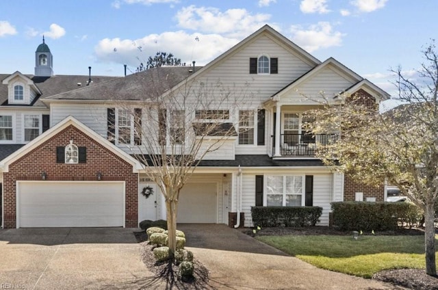 view of front of house with brick siding, a garage, concrete driveway, and a balcony