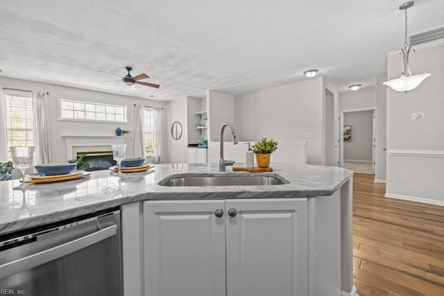 kitchen with a sink, dishwasher, ceiling fan, and a healthy amount of sunlight