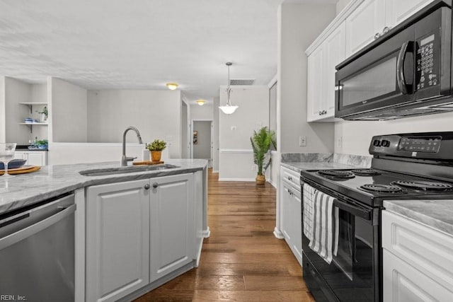 kitchen featuring visible vents, black appliances, dark wood finished floors, white cabinetry, and a sink