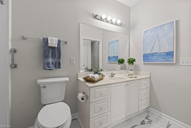 bathroom with vanity, toilet, baseboards, and marble finish floor