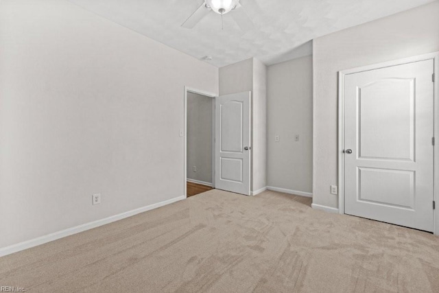 unfurnished bedroom featuring carpet flooring, ceiling fan, and baseboards