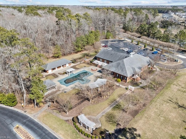 drone / aerial view featuring a wooded view