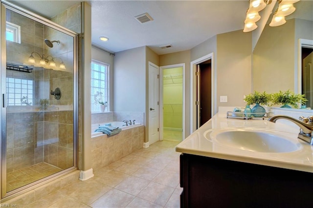 bathroom featuring a sink, visible vents, a stall shower, and tile patterned flooring