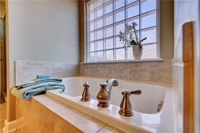 bathroom featuring a wealth of natural light and a garden tub