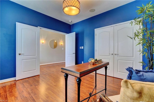 office area featuring baseboards and wood finished floors