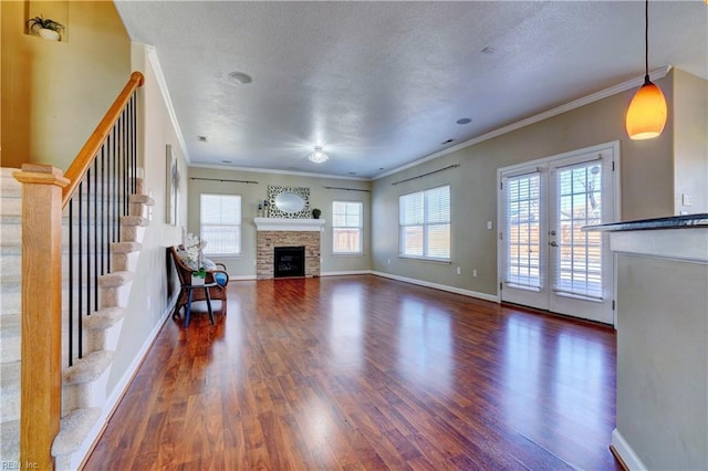 unfurnished living room with plenty of natural light, a textured ceiling, and wood finished floors