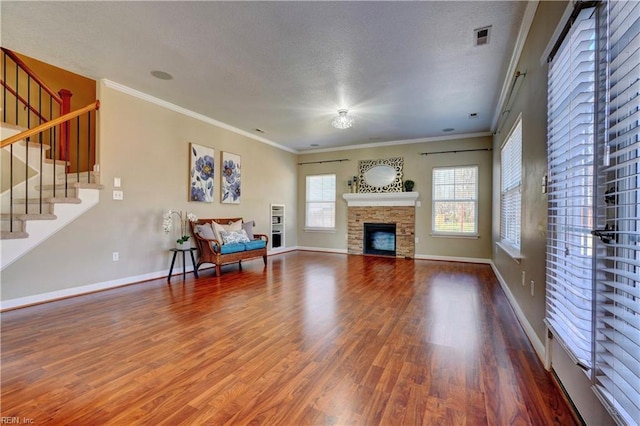 living room with wood finished floors, visible vents, and a textured ceiling