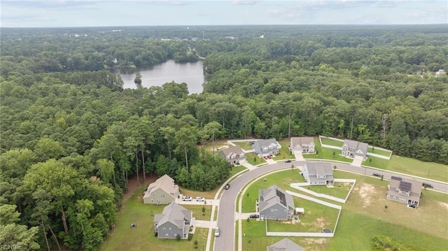 bird's eye view with a view of trees and a water view