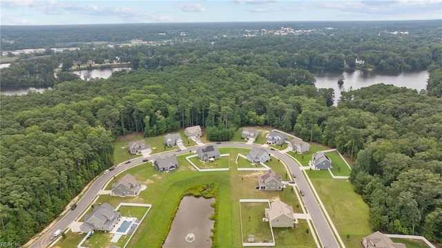 aerial view featuring a forest view and a water view