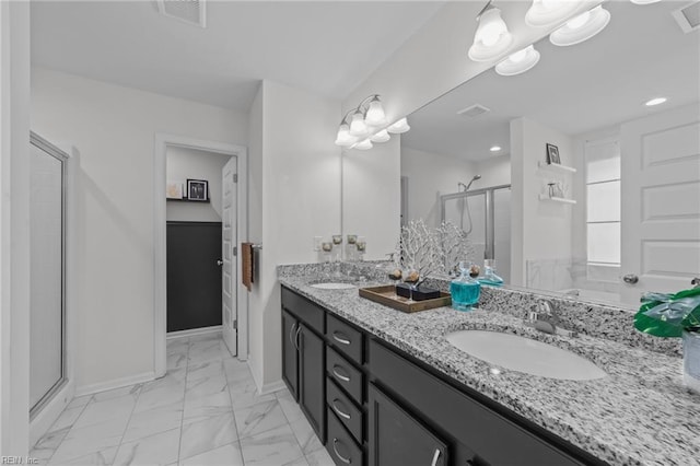 bathroom featuring visible vents, marble finish floor, a stall shower, and a sink