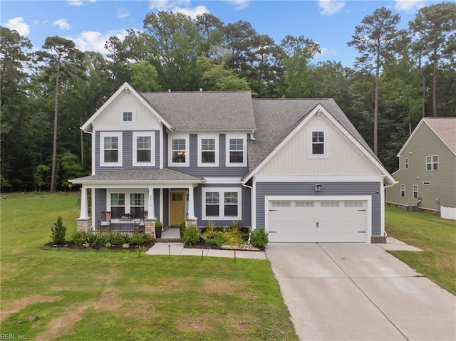 view of front facade with board and batten siding, a front lawn, concrete driveway, roof with shingles, and covered porch