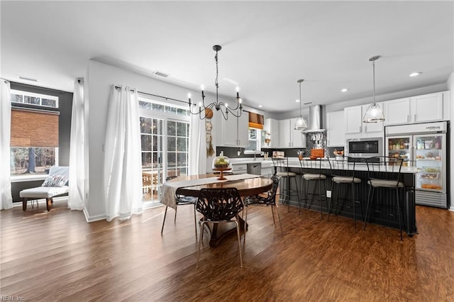 dining area with dark wood-type flooring, recessed lighting, visible vents, and baseboards