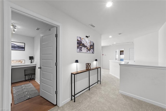 corridor with recessed lighting, visible vents, baseboards, and carpet