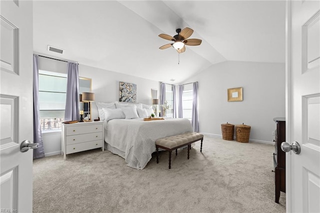 bedroom featuring vaulted ceiling, multiple windows, visible vents, and carpet floors