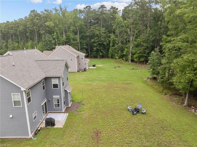 birds eye view of property with a view of trees