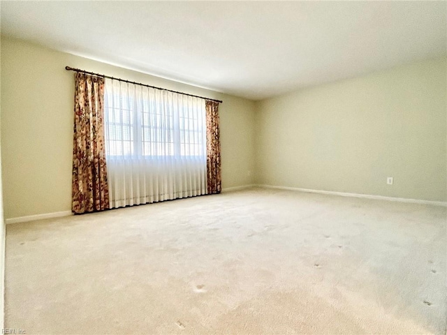 carpeted spare room with baseboards