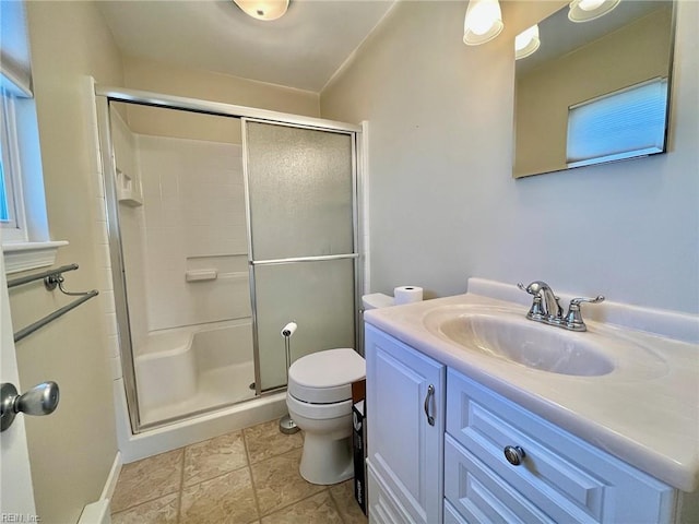 full bathroom featuring vanity, toilet, and a stall shower